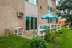 Cannon Falls apartment for rent - a patio with an umbrella outside of a building
