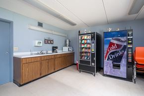 Cannon Falls apartment for rent - a snack room with a vending machine and a sink and a coke refrigerator