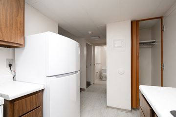 Cannon Falls apartment for rent - A white refrigerator sits in a kitchen next to a white counter.