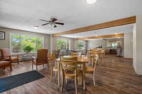 Faribault apartment for rent - a dining area with tables and chairs and a ceiling fan
