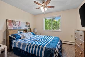 Faribault apartment for rent - the master bedroom has a king sized bed and a ceiling fan