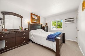 Burnsville townhouse for rent - A bedroom with a bed, dresser, and mirror.