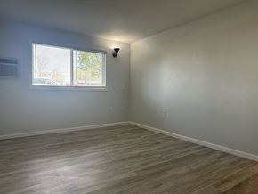 Owatonna apartment for rent - A room with a window and a light on the wall.