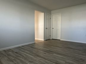 Owatonna apartment for rent - A room with a white door and a wooden floor.
