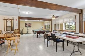 Forest Lake apartment for rent - a game room with tables and chairs and a pool table