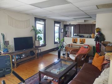 Minneapolis apartment for rent - A living room with a brown couch and a television.