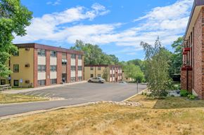 Stillwater apartment for rent - a city street with brick buildings and a parking lot