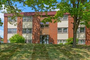 Stillwater apartment for rent - a red brick building with a tree in front of it
