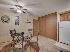 White Bear Lake apartment for rent - a dining room with a table and chairs and a refrigerator