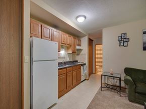 White Bear Lake apartment for rent - a kitchen with white appliances and wooden cabinets and a white refrigerator