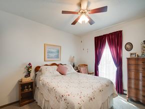 Stillwater apartment for rent - a bedroom with a bed and a ceiling fan