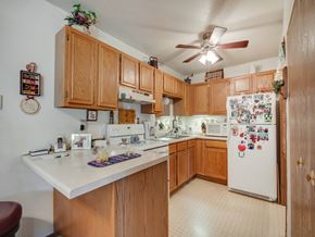 Stillwater apartment for rent - a kitchen with white appliances and wooden cabinets