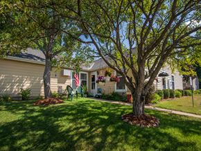 Stillwater apartment for rent - a house with a lawn and trees in front of it
