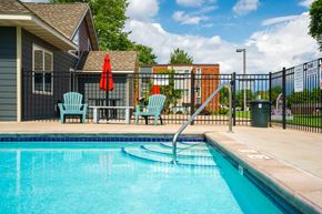 White Bear Lake apartment for rent - our apartments have a resort style pool with chairs and a fence