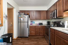 Forest Lake apartment for rent - a kitchen with wooden cabinets and a stainless steel refrigerator