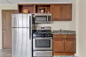 Mankato apartment for rent - a kitchen with stainless steel appliances and wooden cabinets