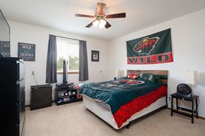 Forest Lake apartment for rent - the master bedroom has a comfy bed and a ceiling fan