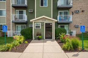 Forest Lake apartment for rent - a walkway in front of an apartment building