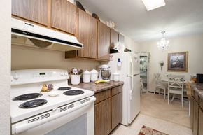 North Branch apartment for rent - A kitchen with a white stove top oven and white refrigerator.