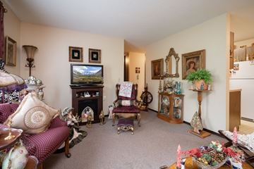 North Branch apartment for rent - A living room with a purple sofa and a television.