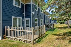 Stillwater apartment for rent - a wooden fence in front of a blue house