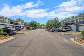 Stillwater apartment for rent - an empty street with houses on either side and cars parked