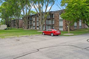 Mankato apartment for rent - a red car parked in front of an apartment building