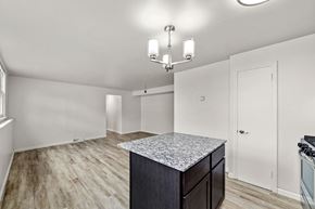 Faribault apartment for rent - A kitchen with a granite countertop and a chandelier.