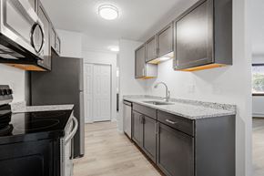 St Cloud apartment for rent - the kitchen of a modern apartment with stainless steel appliances and granite counter tops
