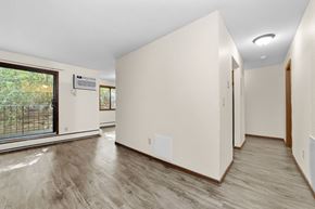 Stillwater apartment for rent - A spacious room with wood flooring and a large window.
