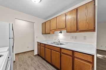 Stillwater apartment for rent - A kitchen with wooden cabinets and a white countertop.