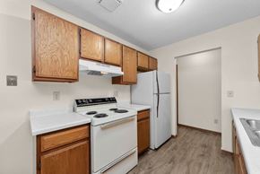 Stillwater apartment for rent - A kitchen with white appliances and wooden cabinets.