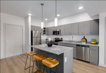 Mesa apartment for rent - A modern kitchen with a marble countertop and stainless steel appliances.