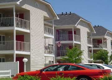 Meridian apartment for rent - a red car parked in front of an apartment building