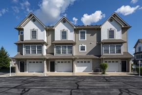 Perrysburg apartment for rent - A large, two-story house with a garage on the ground floor.