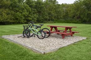 Bryan apartment for rent - A green bike is parked next to a red picnic table.