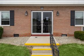 Bryan apartment for rent - A brick house with a glass door and a yellow step.