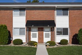 Waterville apartment for rent - A brick building with a white door and windows.