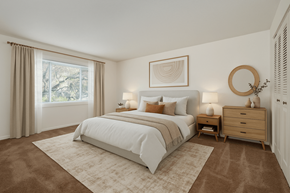Toledo apartment for rent - A bedroom with a large bed, a dresser, and a mirror.