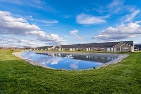 Findlay apartment for rent - A large building with a pool in front of it.