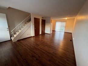 Waterville apartment for rent - A room with wooden floors and a staircase.