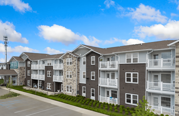 An exterior view of an apartment building on a street