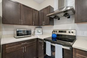 Fort Wayne apartment for rent - a kitchen with a stove top oven and a microwave at 41 North Apartments, Fort Wayne, IN 46835