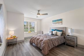 Fort Wayne apartment for rent - a bedroom with a bed and a ceiling fan at Morada at Maysville, Fort Wayne, IN