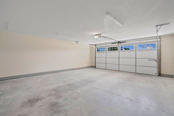The interior of a garage with white walls and white garage doors