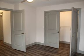 Plainfield apartment for rent - an empty room with three doors and a wood floor  at Haven Homes Apartments, LP, Plainfield, 46168