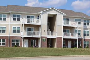 Daleville apartment for rent - a building with two balconies and a lawn at Salem Place Apartments, Daleville, IN