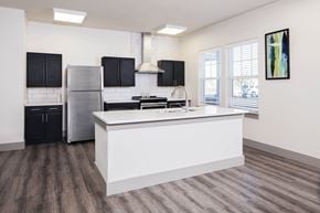 Fishers apartment for rent - a kitchen with a large island and a stainless steel refrigerator at Ritchey Reserve, Indiana
