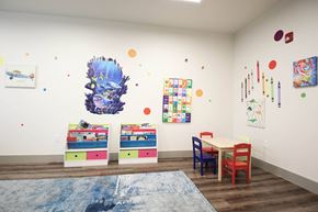 Fishers apartment for rent - a play room with a table and chairs and paintings on the wall at SouthPointe Village Apartments, LP, Fishers, Indiana