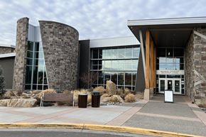 Montrose apartment for rent - A modern building with a stone facade and large glass windows.
